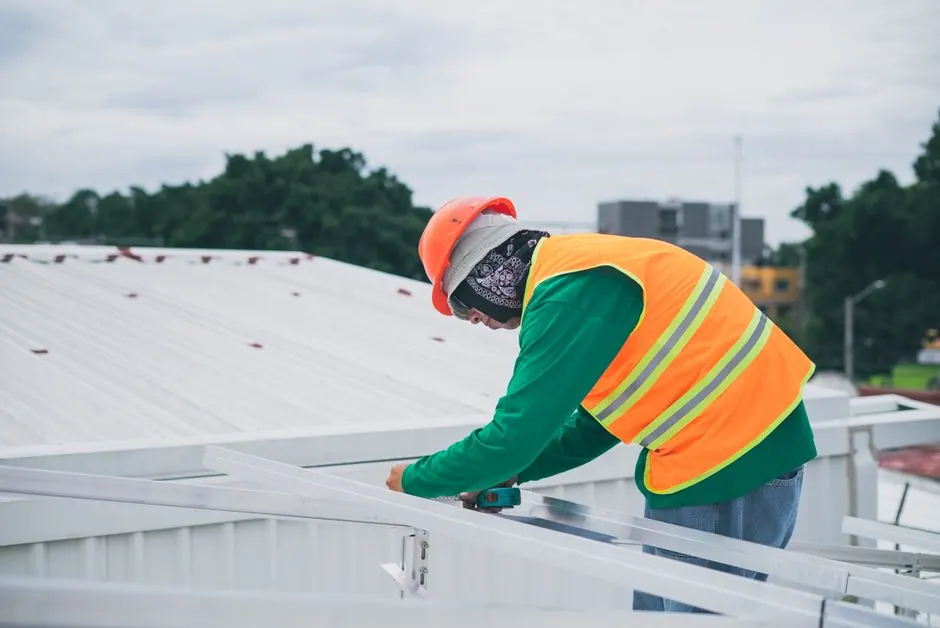Standard Roofing crew installing James Hardie siding on a Houston home